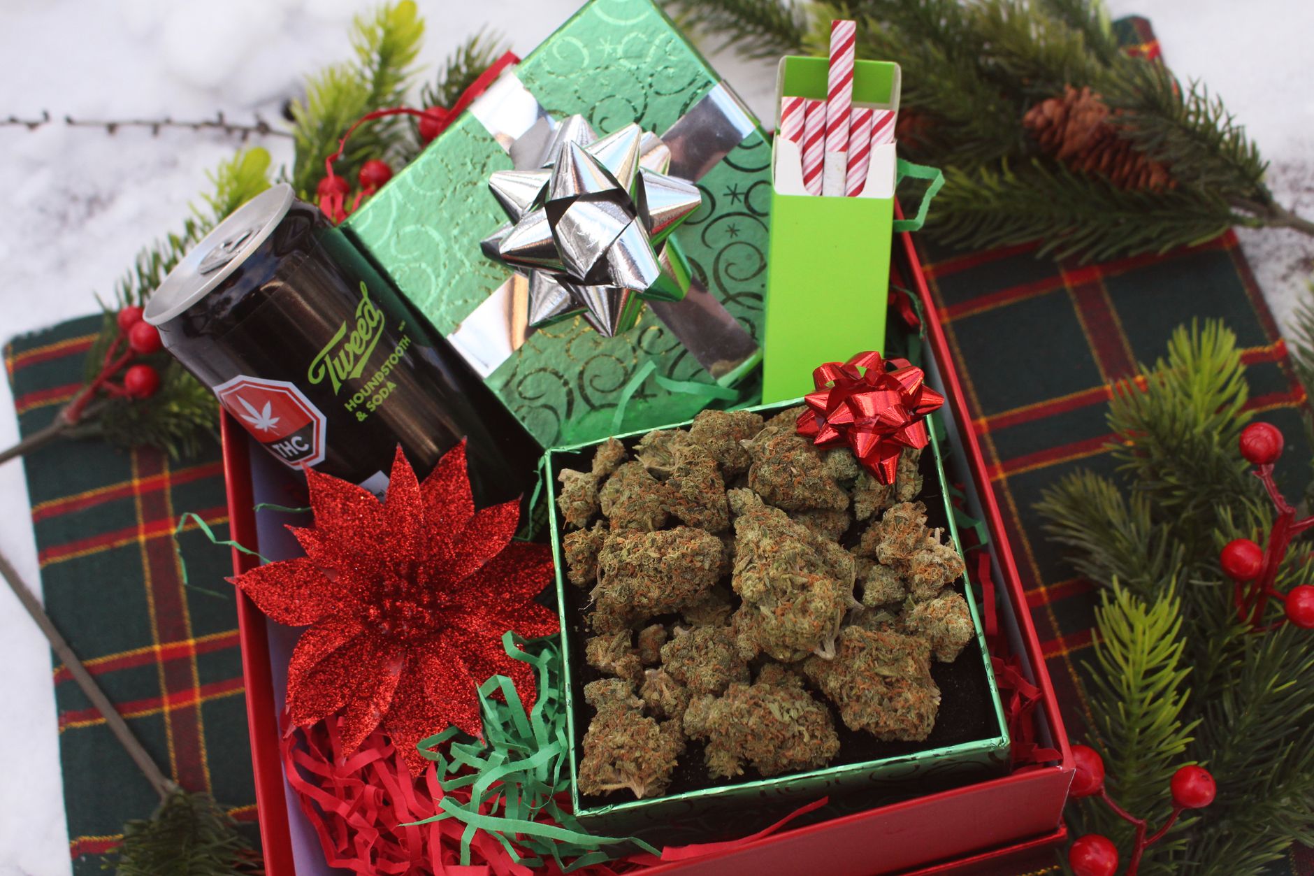 Creative holiday gift set featuring cannabis buds, THC beverage, and festive decorations, perfect for Christmas gifting.