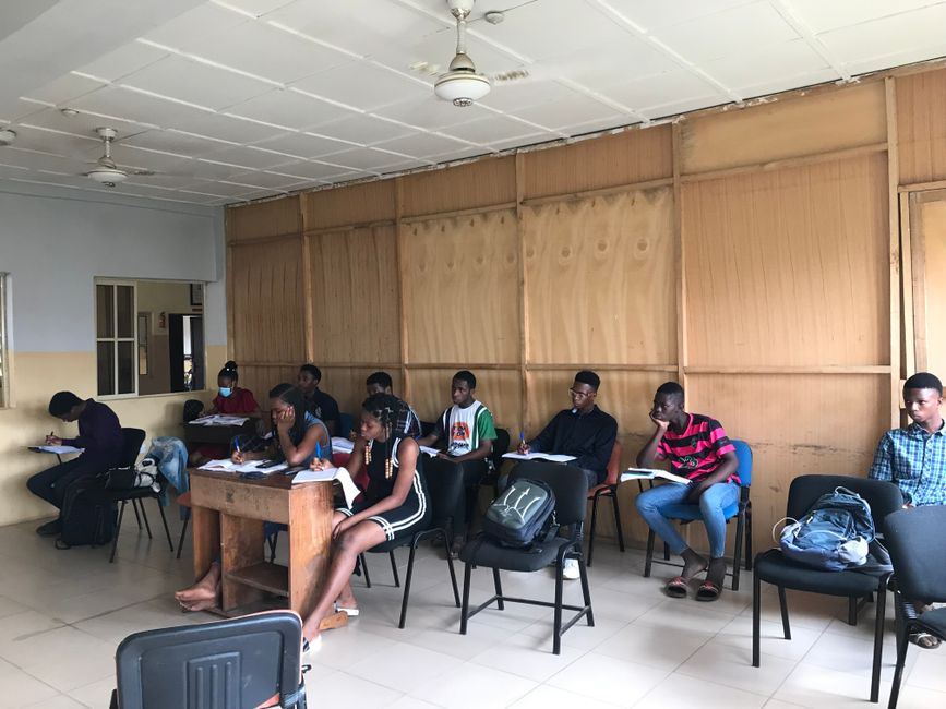 African students focused on learning and taking notes in an indoor classroom setting. African students focused on learning and taking notes in an indoor classroom setting.
