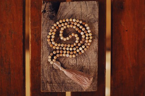 Free Wooden prayer beads arranged on rustic wood, conveying meditation. Stock Photo