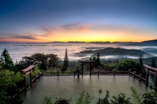 Gateway and Courtyard to a Hilltop Buddhist Temple Overlooking a Scenic Landscape