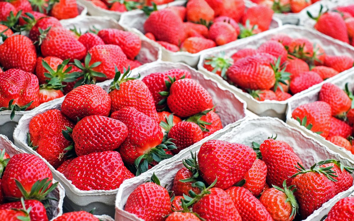 Vibrant red strawberries arranged fresh, the key ingredient for strawberry coconut rum punch