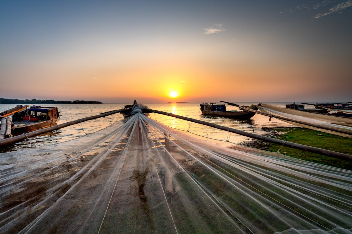 Fishing Boats Near Shore During Sunset