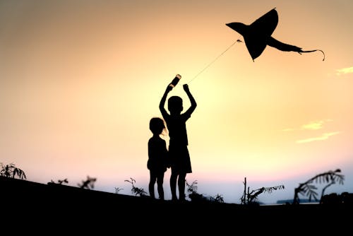 Silhouette of Children with Kite