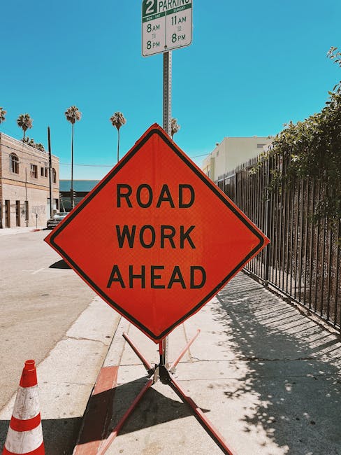 Clear and vibrant road work sign on a sunny Los Angeles street, ensuring safety and awareness.