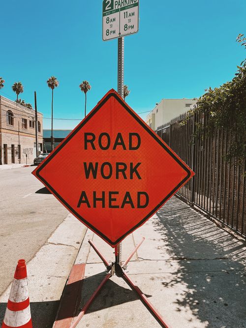 Free Clear and vibrant road work sign on a sunny Los Angeles street, ensuring safety and awareness. Stock Photo