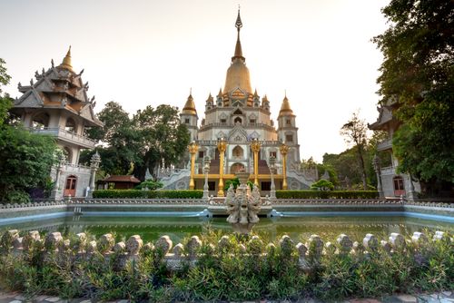 Free Stunning temple showcasing traditional architecture surrounded by lush gardens and serene water features. Stock Photo