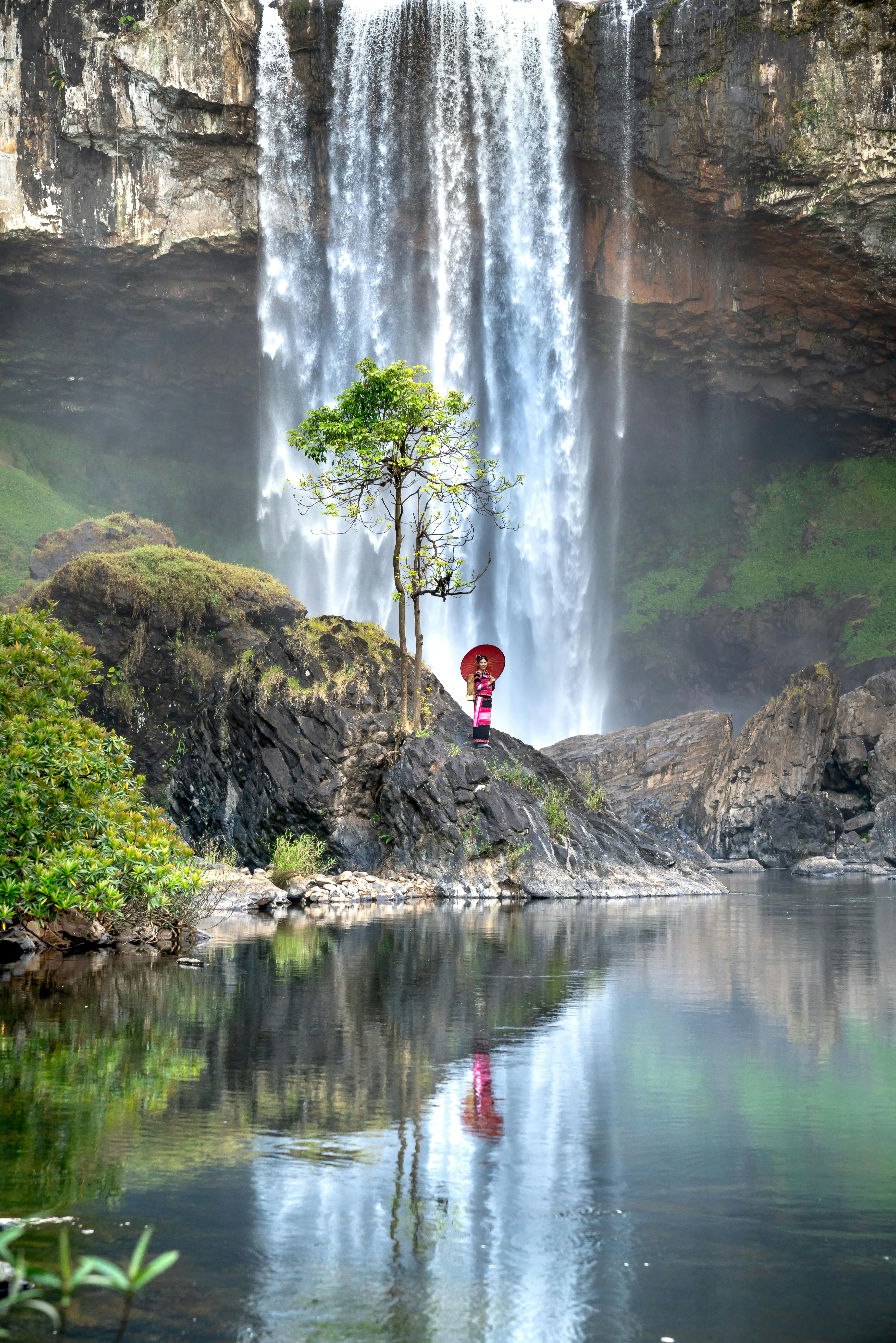 Woman Standing under Waterfall on Kon Ha Nung Plateau, Vietnam · Free
