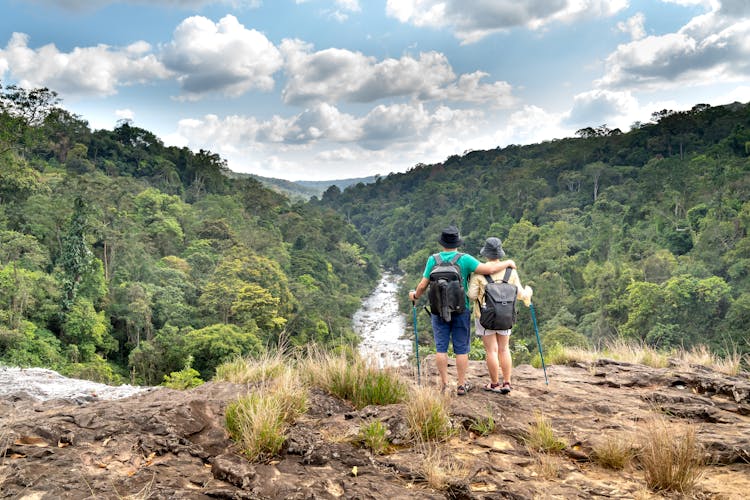 Couple Hikers Standing On Mountain Peak