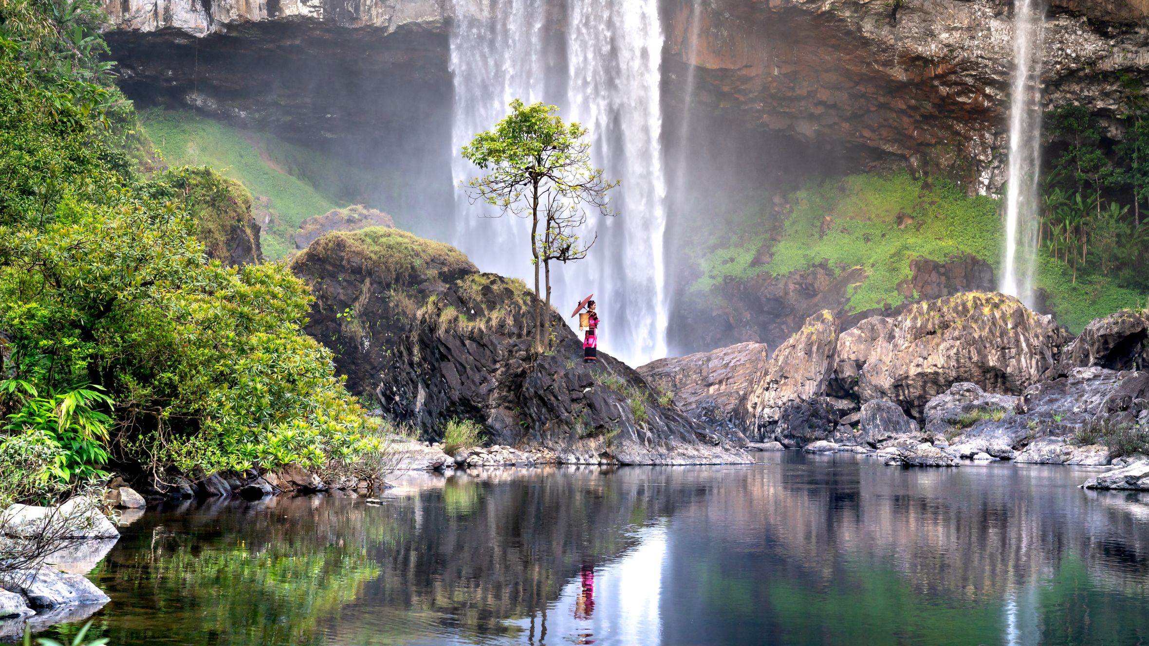 Photographer captures serene waterfall and pool in verdant Vietnamese landscape.