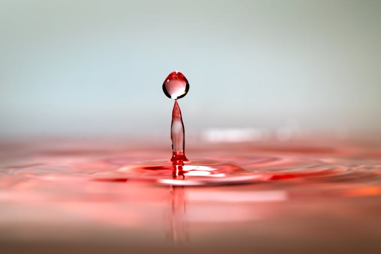 Droplet Falling Into Red Dyed Water