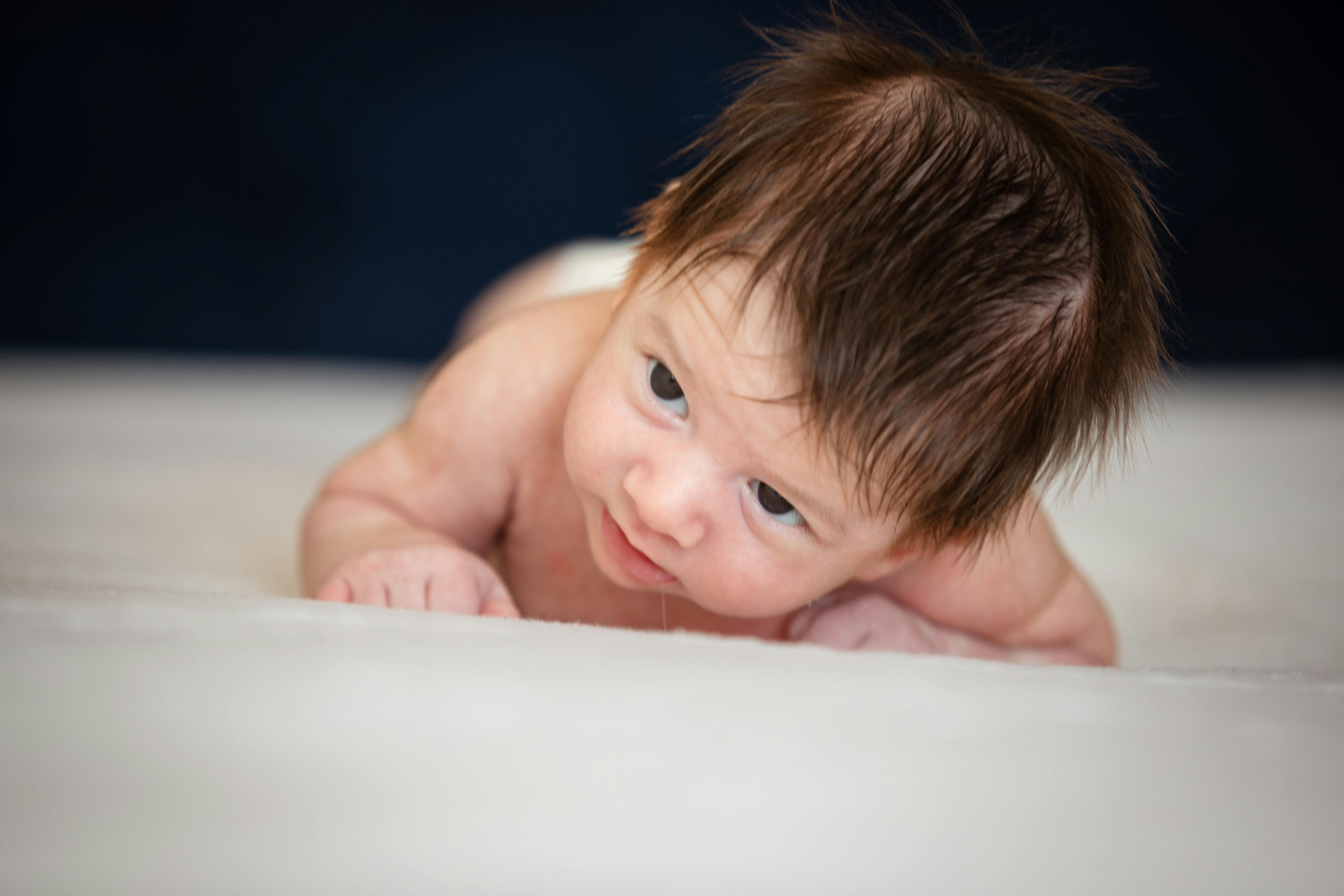 Baby Boy Lying Flat on Bed · Free Stock Photo