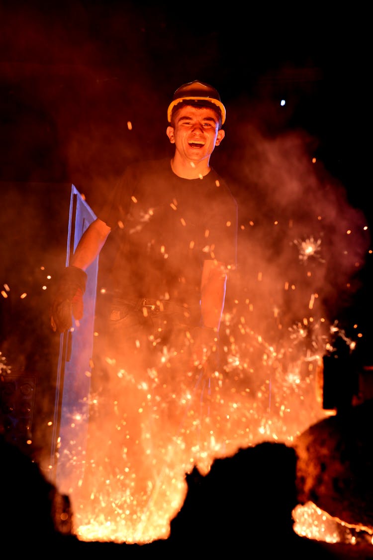 Smiling Man In Fire At Building Site