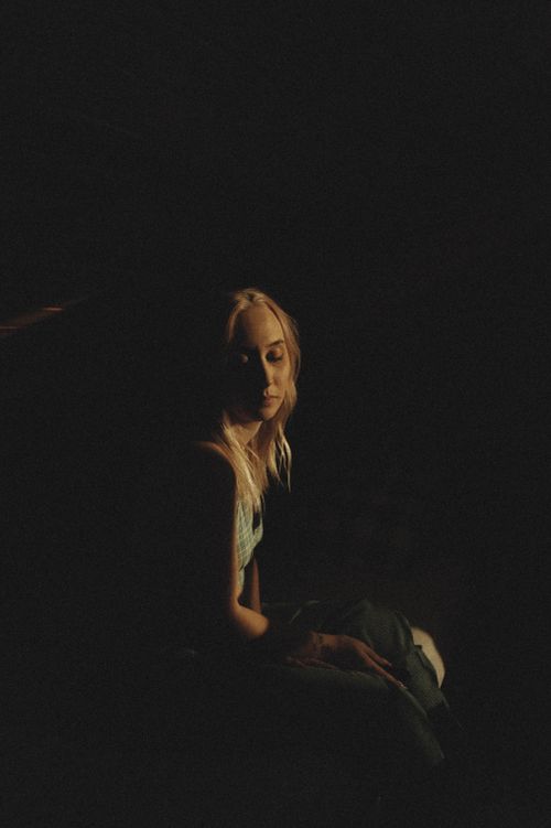 Free Artistic low-light portrait of a woman with closed eyes and serene expression. Stock Photo
