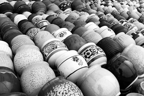 Grayscale Photo of Clay Pots with Different Designs