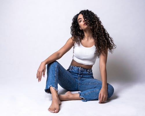Studio Shot of a Young Woman Wearing Jeans and White Top 