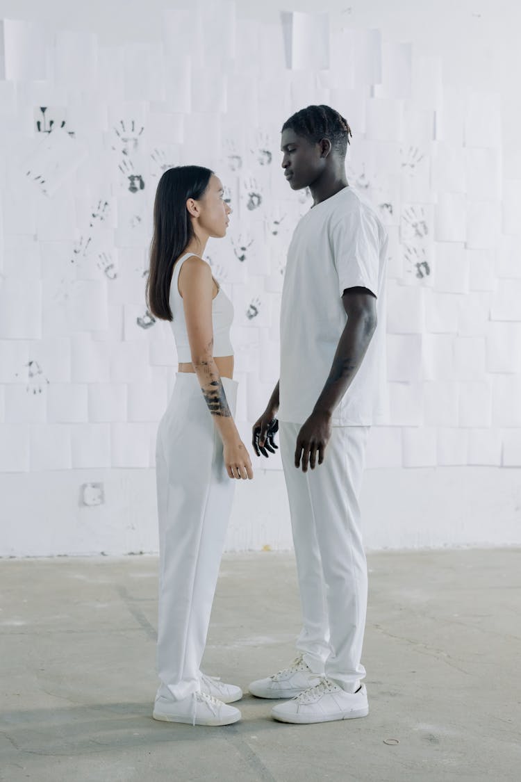 A Man And Woman Standing While Facing Each Other