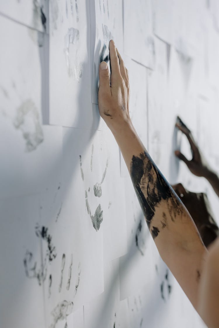 Hand Making Handprints On Paper