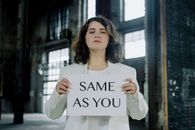 Woman in White Long Sleeve Shirt Holding White Paper