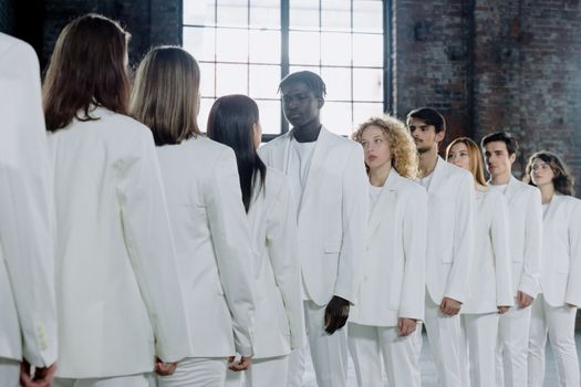 Man in White Suit Standing Beside Woman in White Dress
