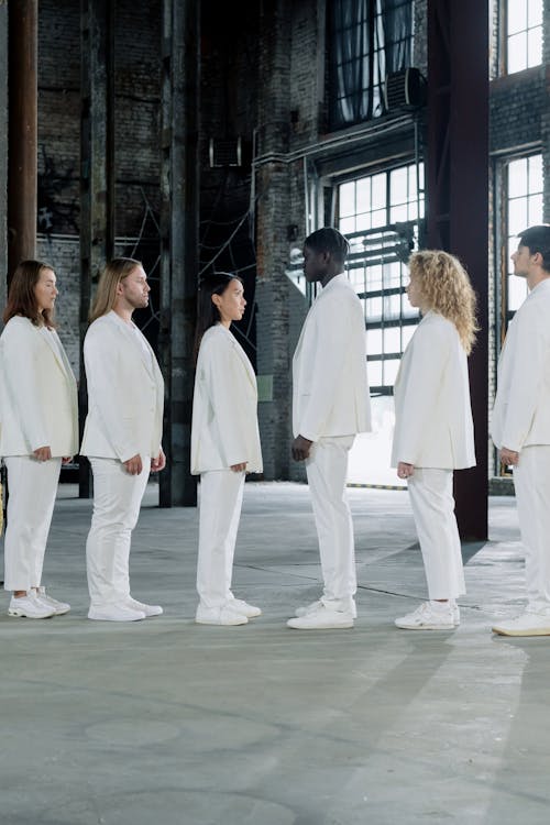 Free A Group of People Wearing White Uniform in a Line Facing Each Other Stock Photo