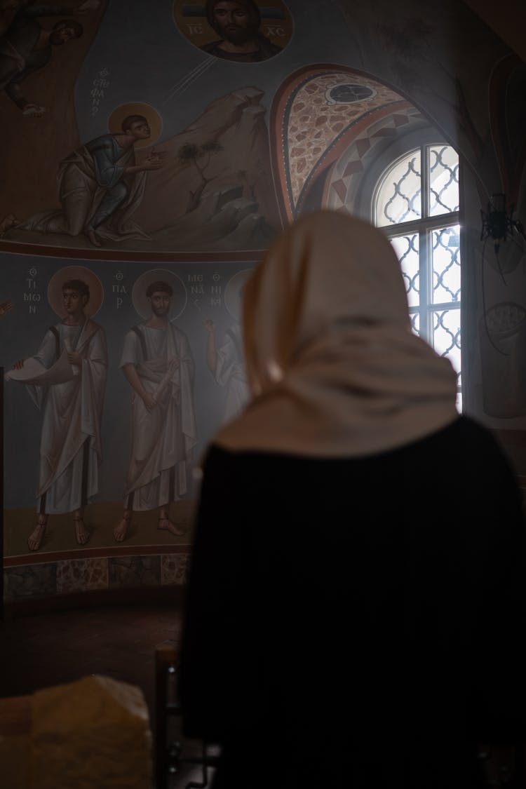 Unrecognizable Woman Praying In Church Interior With Fresco