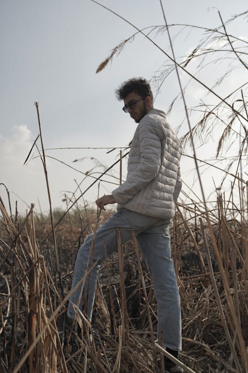 Man in Jacket Walking on Field