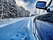 Snow Covered Road Between Trees Under Cloudy Sky
