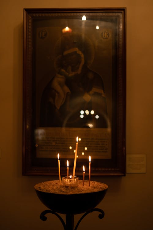 Candles in front of Icon of Virgin Mary in Orthodox Church