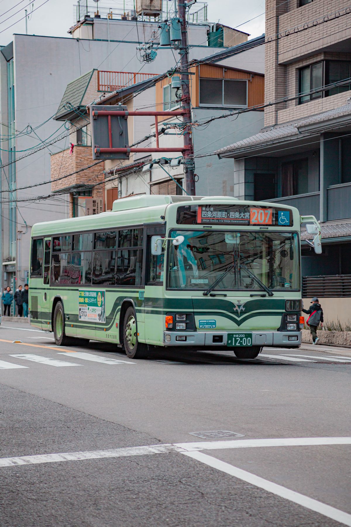 A Kyoto city bus on a typical urban street, the easiest way to reach Kinkaku-ji