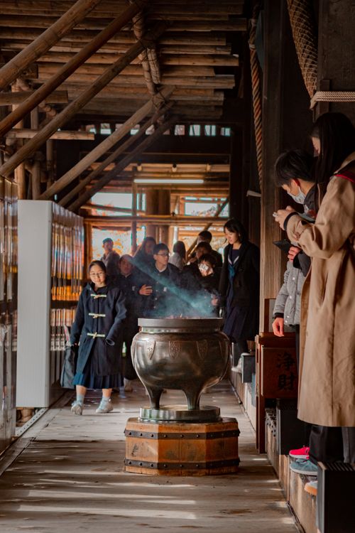 Free People gathered around a large smoking cauldron in a traditional wooden hallway, engaging in cultural rituals. Stock Photo