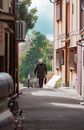 Man in Black Jacket Walking on Sidewalk