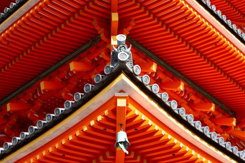 Free Close-up of vibrant red and orange Japanese temple roof showcasing intricate architectural design. Stock Photo