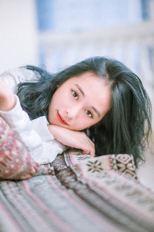 Free Close-up of a Young Woman in Lying in Bed Stock Photo