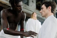 A Shirtless Man Looking at the Man in White Shirt
