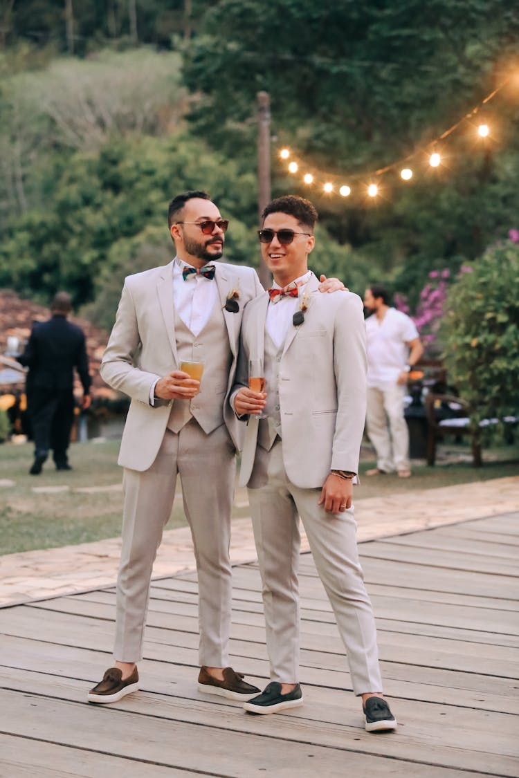 Boyfriends In Suit Wearing Sunglasses At Outdoor Event