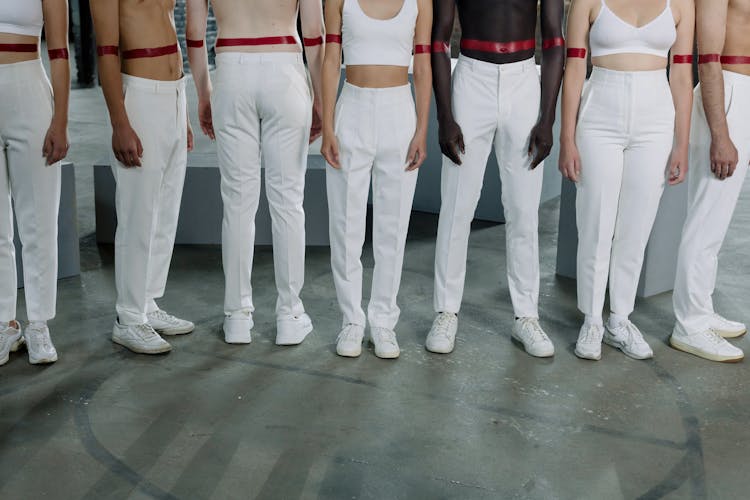 People In Line Wearing White Pants