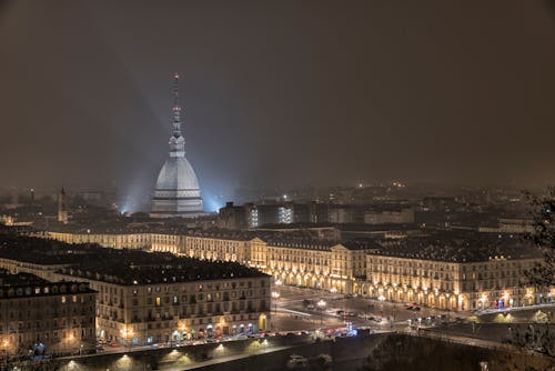 Mole Antonelliana over Turin Buildings at Night