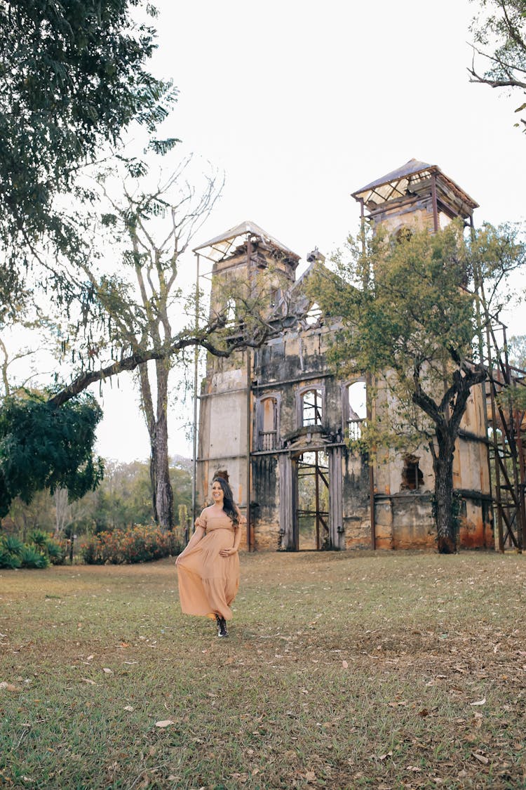 Pregnant Woman Walking Near Old Castle