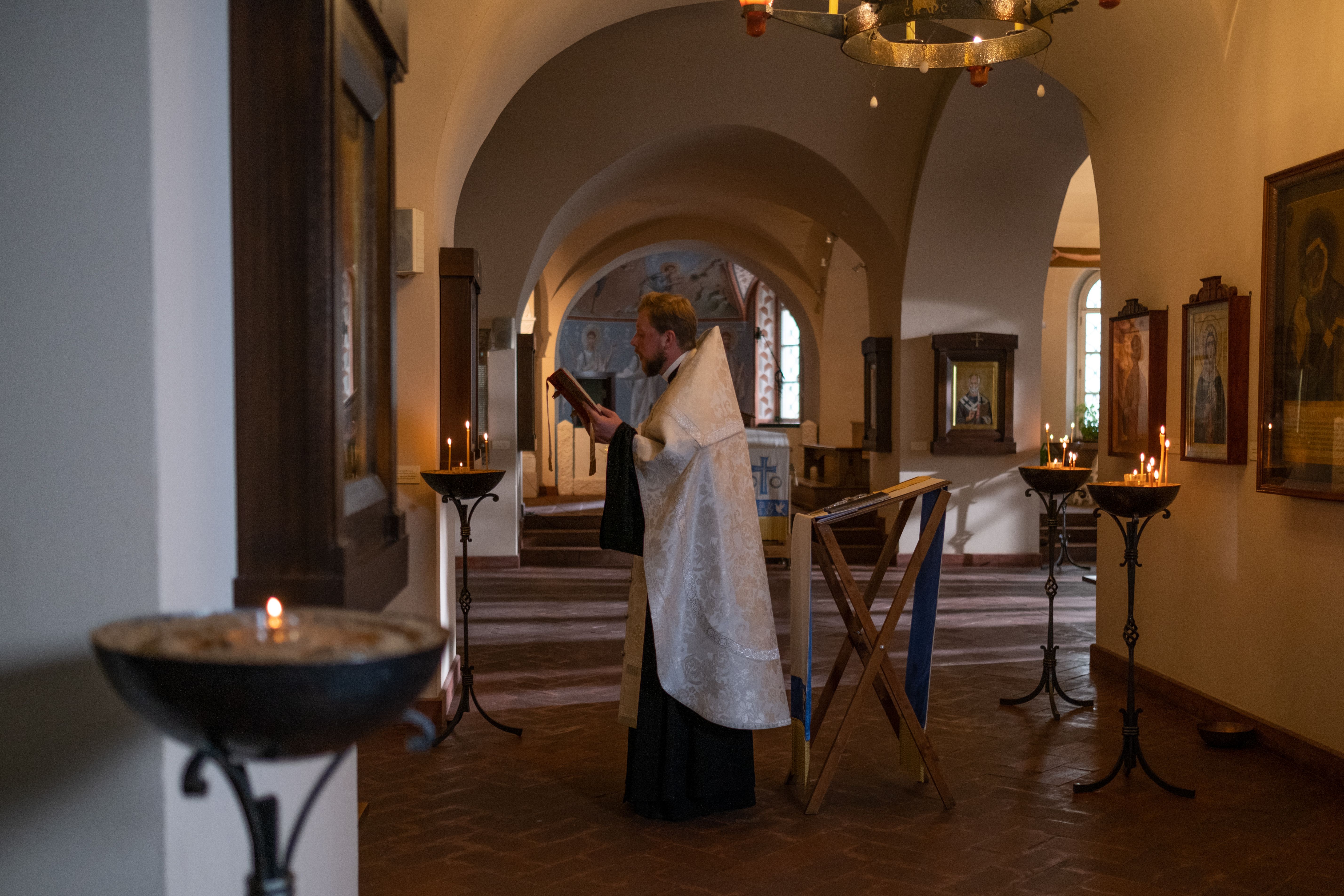 ancient candlelit prayer ritual in a quiet stone church