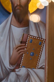 A close-up of an Orthodox religious icon featuring a figure holding a decorated book.