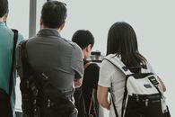 Man in Gray Shirt Standing Beside Woman in Black Shirt