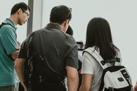 Man in Black T-shirt Standing Beside Woman in White Shirt