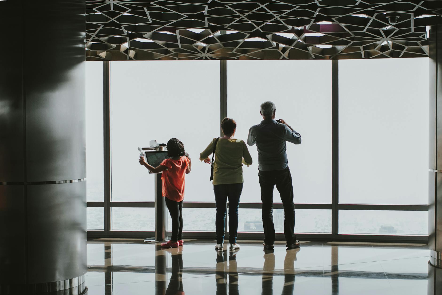 Family enjoying the skyline view from an indoor observation deck in Dubai.