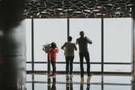 3 Men Standing in Front of Window