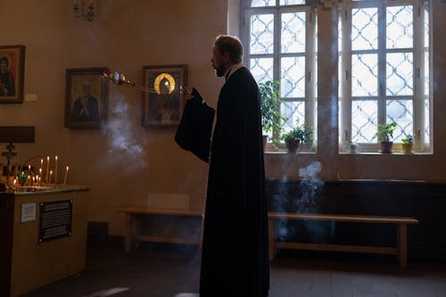 Priest Standing with Incense at Orthodox Church