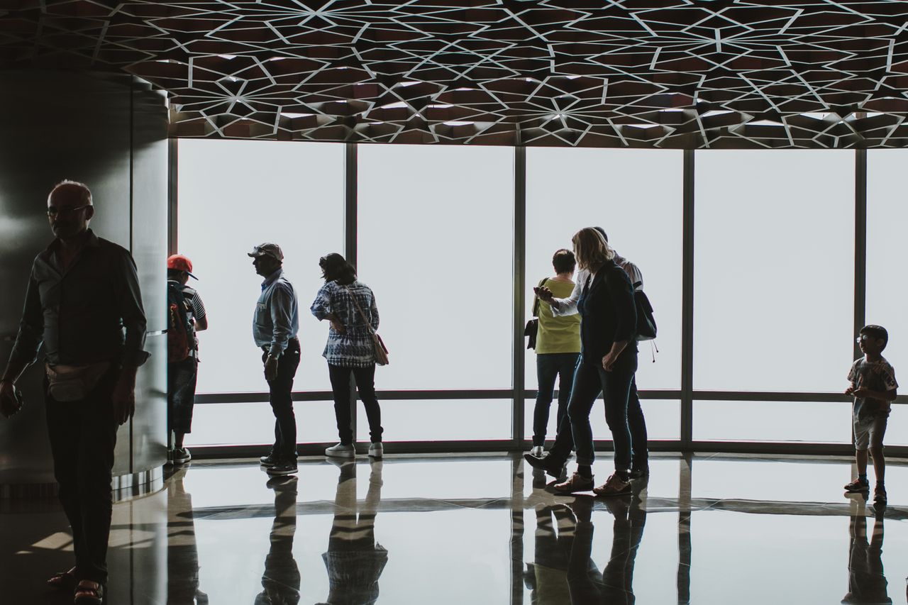 Visitors at the floor-to-ceiling windows of the Burj Khalifa observation deck