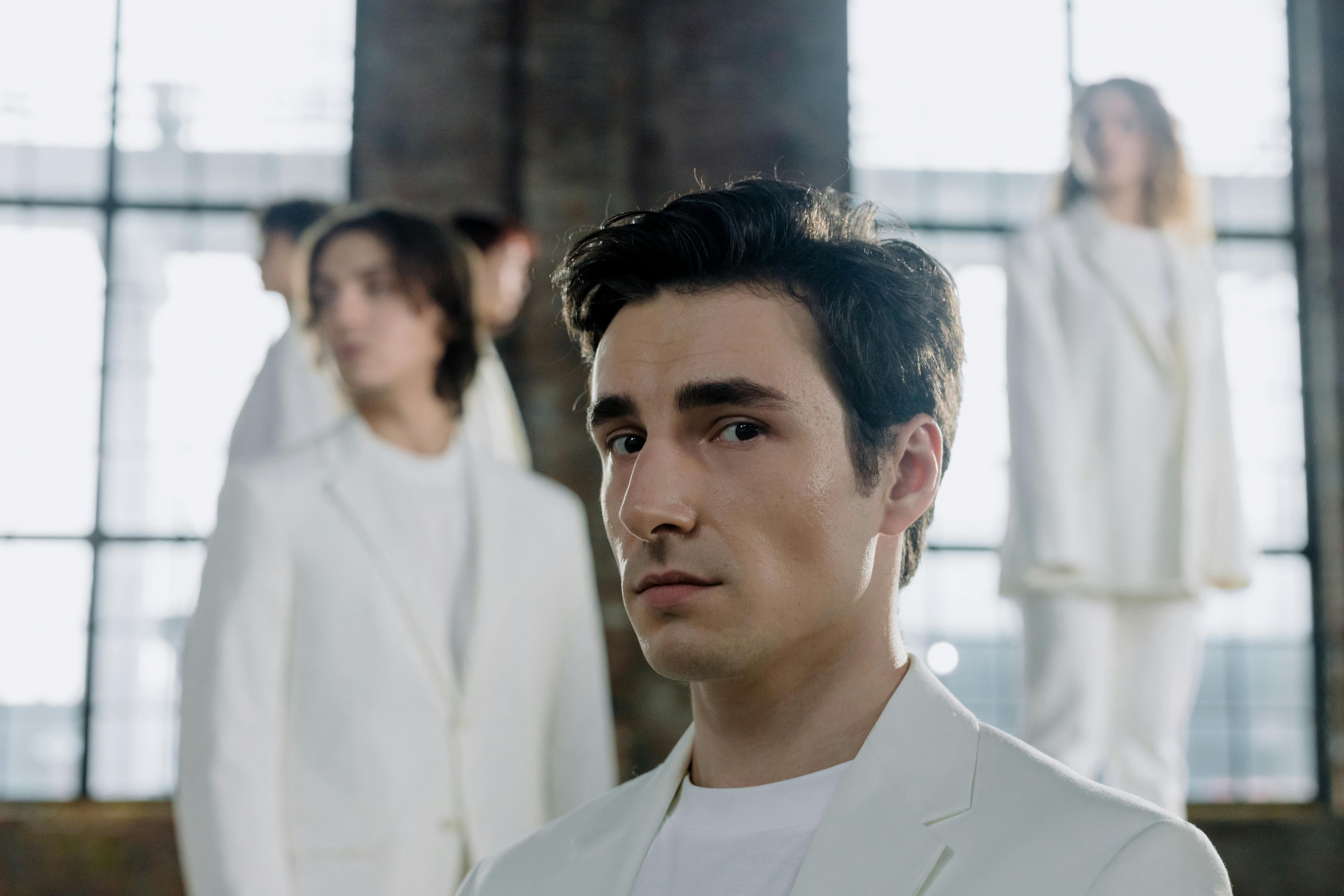 Portrait of Man with Models Standing behind · Free Stock Photo