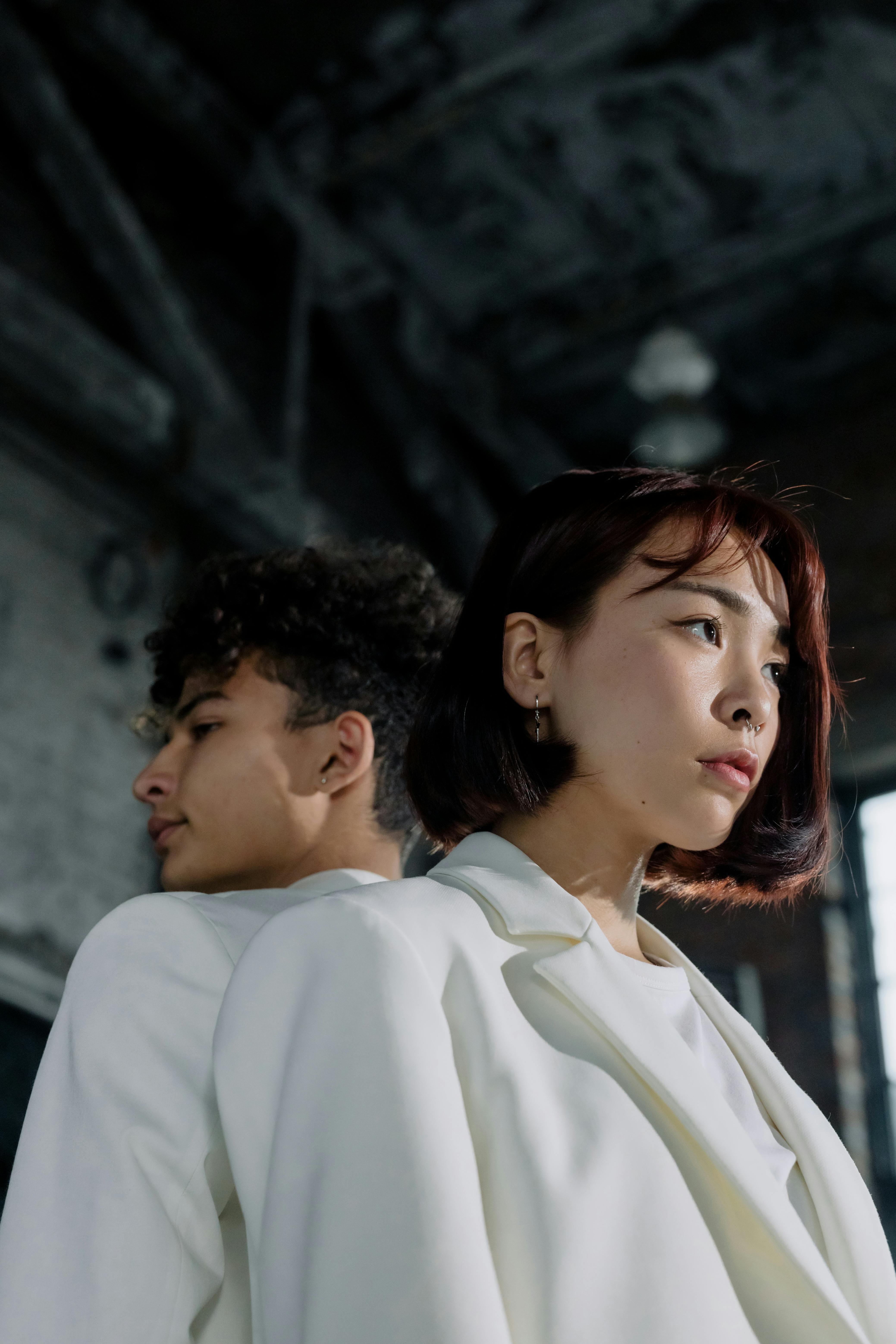 low angle shot of two people in white blazers