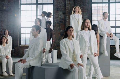 Group of People in White Suits Standing in the Room