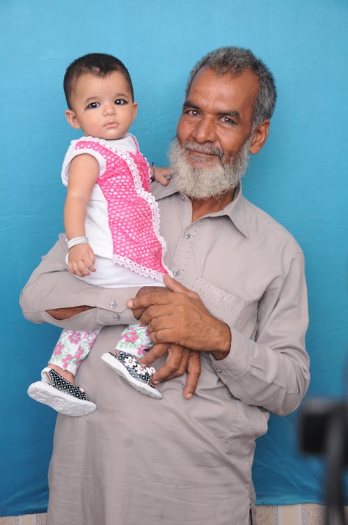 Grandfather carrying his Grandchild 